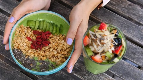Woman Hands Holding Vegan Avocado Smoothie Bowl For Healthy Breakfast.