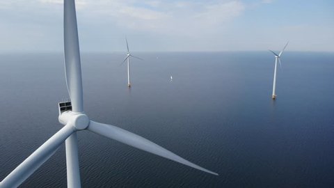 Offshore Windmill farm in the ocean  at the lake IJsselmeer by Urk Netherlands, isolated windmill park at sea, drone view from above out the sky
bird eye view