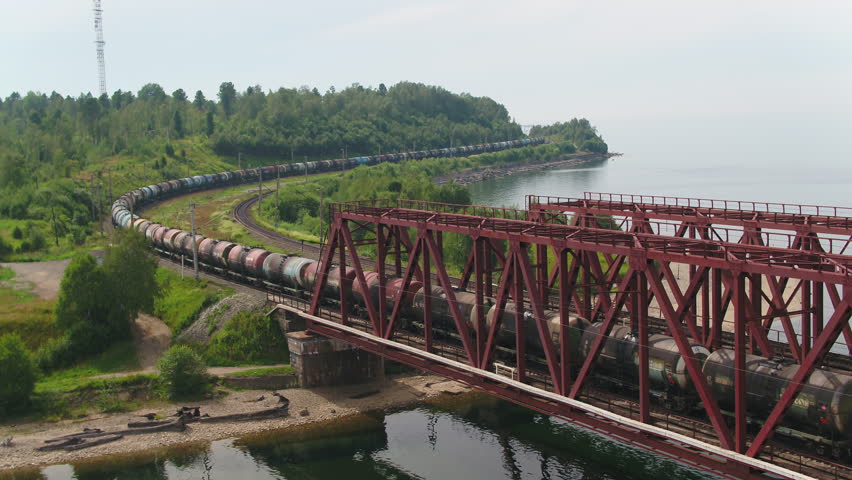 epic flying view. bridge road. street train traffic transportation. lake river pond. panorama landscape. 4k