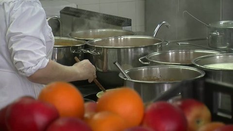Close-up of chef hands cooking and preparing food. 