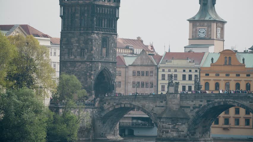 Crowded Charles bridge across the Vltava river in Prague, the Czech Republic