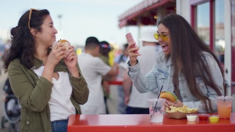 Excited Tourists Pose With Their Burgers For Fun Vacation Selfies On The Santa Monica Pier (Shot On Red Scarlet-W Dragon In 4K, Slow Motion)