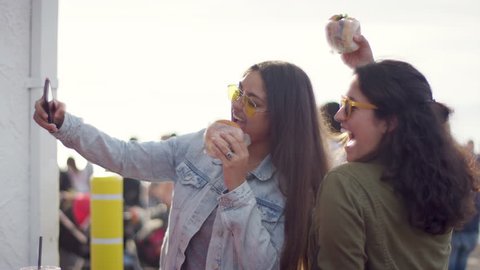 Excited Young Women Pose With Their Burgers For Fun Vacation Selfies On The Santa Monica Pier (Shot On Red Scarlet-W Dragon In 4K, Slow Motion)
