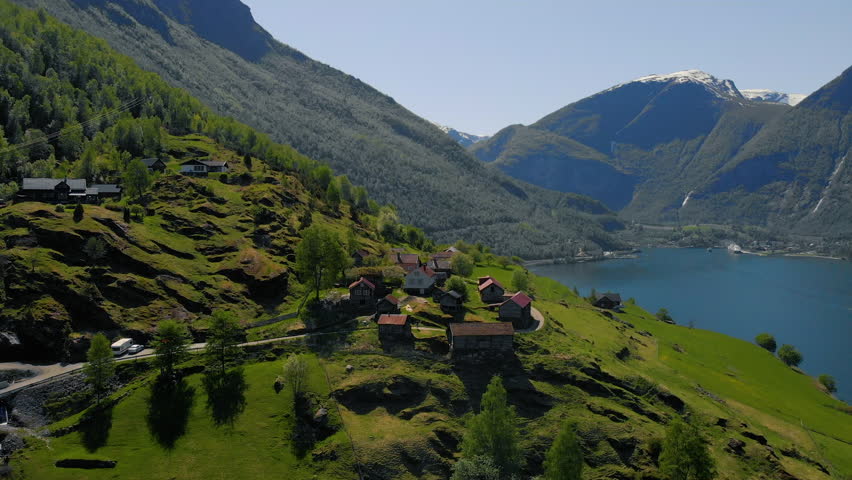 Otternes is a historic cluster and row of 18th-century farms, including 26 buildings. This collection of buildings enjoys wonderful views over the Aurland Fjord, about 2½ miles from Flåm. Drone 4k Royalty-Free Stock Footage #1011352394