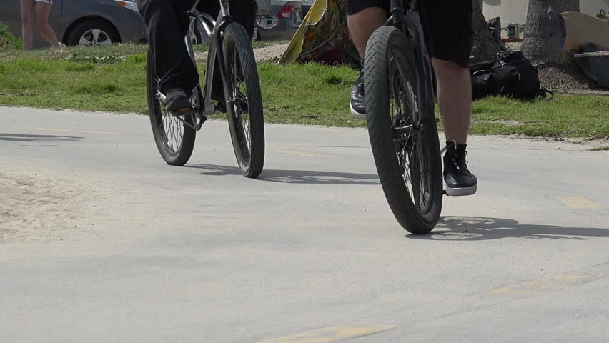 Bikes, skateboards and rollerblades going past on the beach bike path