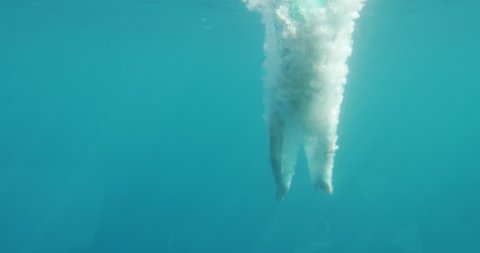 Underwater Footage of Man Jumping into Water and Swimming. Diving in the Ocean. Shot on RED Epic 4K UHD Camera.