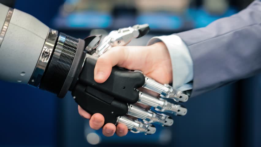 Hand of a businessman shaking hands with a Android robot. The concept of human interaction with artificial intelligence. Royalty-Free Stock Footage #1011353930