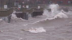 Huge powerful waves breaking at seawall in major severe storm in hurricane force winds - Powered by Shutterstock - Get 15% off with code: PIKWIZARD15