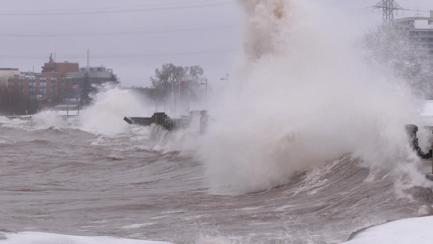 Huge powerful waves breaking at seawall in major severe storm in hurricane force winds Royalty-Free Stock Footage #1011370475