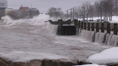 Huge powerful waves breaking at seawall in major severe storm in hurricane force winds