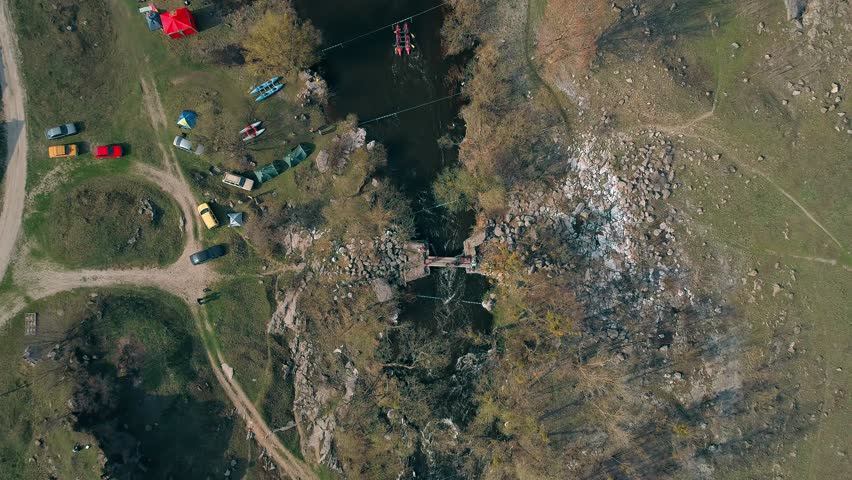 Aerial view of people on the bridge. Flow. River. Trees.