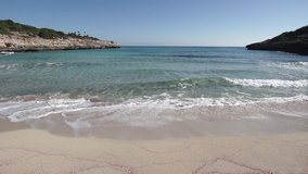 Soft waves at beach of Cala Marcal, beautiful seaside on Majorca island, Mediterranean Sea, Spain Balearic Islands
