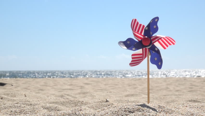 July 4th spinner with stars and stripes on the beach Royalty-Free Stock Footage #1011377786