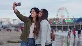 Friends Take Cute Vacation Selfies Together On The Beach, Santa Monica Pier In Background (Shot On Red Scarlet-W Dragon In 4K, Slow Motion)  - Powered by Shutterstock - Get 15% off with code: PIKWIZARD15