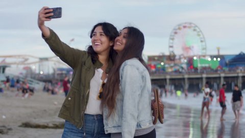 Friends Take Cute Vacation Selfies Together On The Beach, Santa Monica Pier In Background (Shot On Red Scarlet-W Dragon In 4K, Slow Motion) 