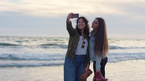 Friends Walk Along Water's Edge At Beach During Sunset, They Stop To Take A Cute Vacation Selfie Together (Shot On Red Scarlet-W Dragon In 4K, Slow Motion) - Powered by Shutterstock - Get 15% off with code: PIKWIZARD15