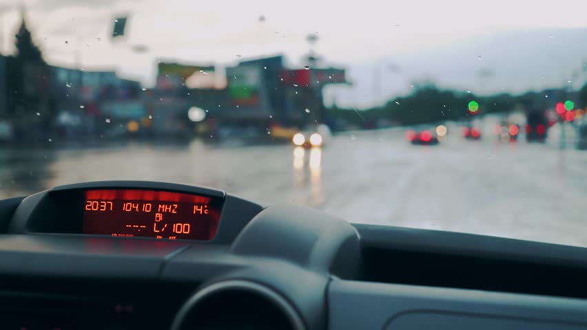 Control panel in the car close-up. Windscreen at the time of the rain. | Shutterstock HD Video #1011385268