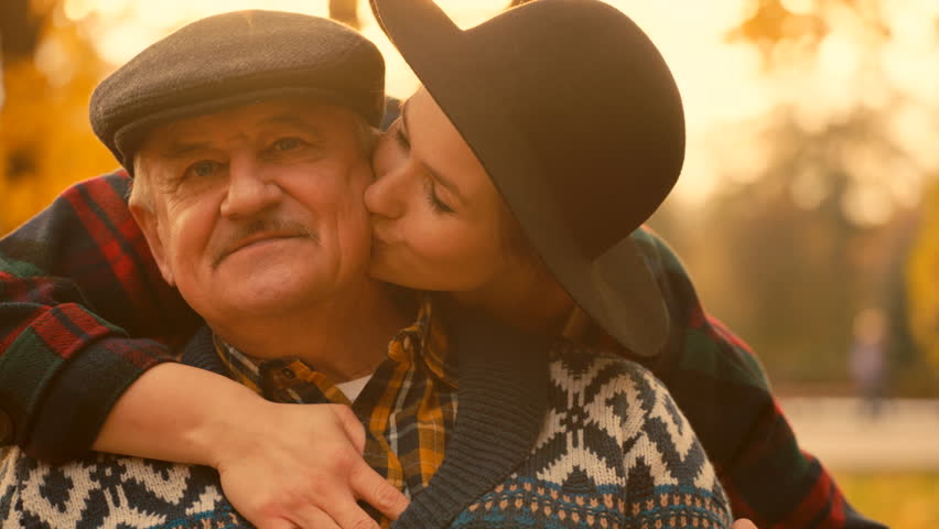 Young woman is kissing her senior father's cheek on the meeting in the autumn park Royalty-Free Stock Footage #1011391895