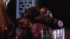 Dried date fruits in low light. Selective focus.