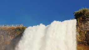 Slow motion video: the famous Niagara Falls. The bottom view of shooting against the blue sky