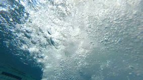 
Professional video of blue underwater bubbles rising to surface in slow motion 250fps
