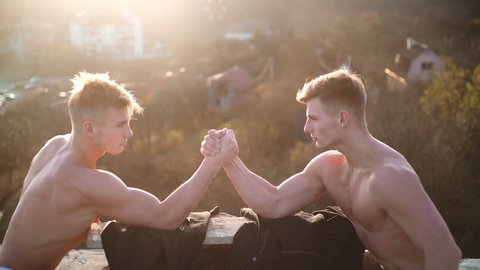 Two men arm wrestling. Arms wrestling, competition. Rivalry concept - close up of male arm wrestling. Leadership concept. Rivalry, vs, challenge, strength comparison.