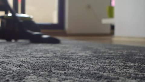 Woman Clearing Grey Carpet Using Vacuum Dust Cleaner