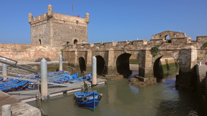 Blue fishing boats near fort in the port of Essaouira, Morocco, 4k