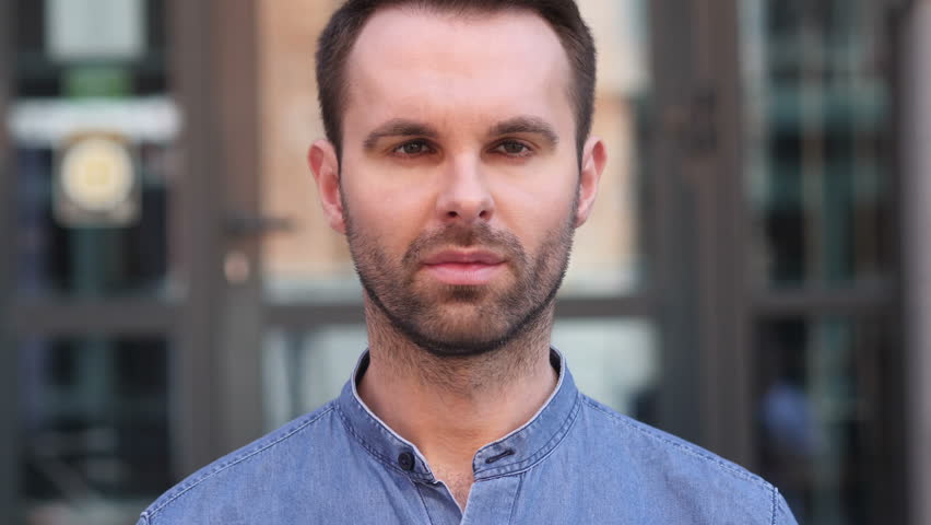 Serious Casual Man Looking at Camera