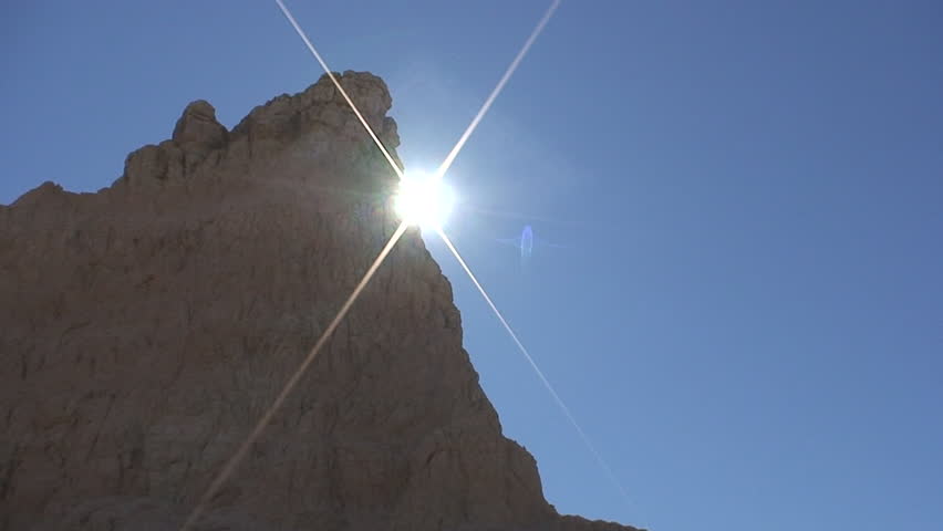 Badlands in Summer Sun Flare Cross Wall Peak in South Dakota