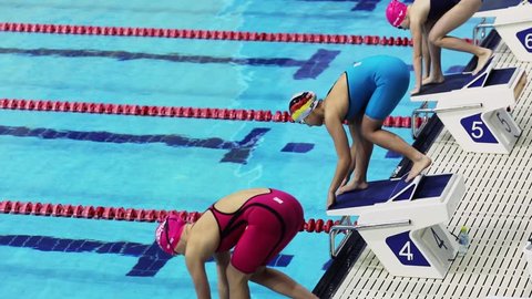 KAZAN, RUSSIA - DEC 09, 2017: Women start race in Burevestnik basin during All Russia Swimming Championship, Alexander Popov Cup. Slow motion