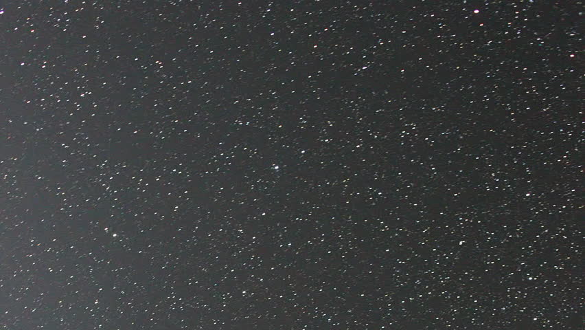 Milky Way galaxy core rotates across a dark star-filled sky. Dense clusters of stars and cosmic dust lanes drift slowly from one edge of the frame to the other, revealing the luminous galactic center with its characteristic mix of bright stellar regions and dark nebulous patches. The scene is captured in a fixed vertical orientation, emphasizing the vast scale of the cosmos against an inky black backdrop. The motion is smooth and continuous, typical of long-exposure astrophotography timelapse techniques. No terrestrial landscape, mountains, or foreground elements are visible in this view. The footage is suitable for use as a space-themed background, scientific visualization, or celestial screensaver content. Vertical video.