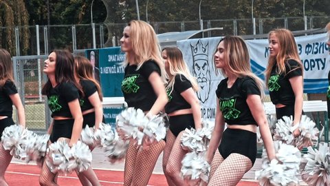 VINNITSA, UKRAINE - MAY 2018: Performance of beautiful young girls of cheerleader team. Team performance cheerleader on stadium