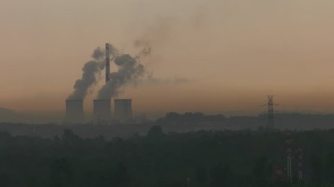 Power plant block. Water vapor rises to the sky. Energy poles and chimneys in the background. Sunrise and fog. 4K. Closeup