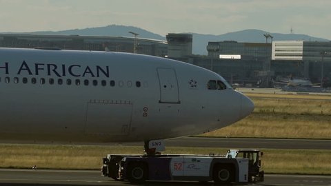FRANKFURT AM MAIN, GERMANY - JULY 19, 2017: Close-up of Airbus A340 of South African airways towing by tow vehicle