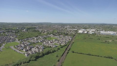 aerial birds eye from outside ennis county clare. ennis skyline with housing estate on a sunny day.