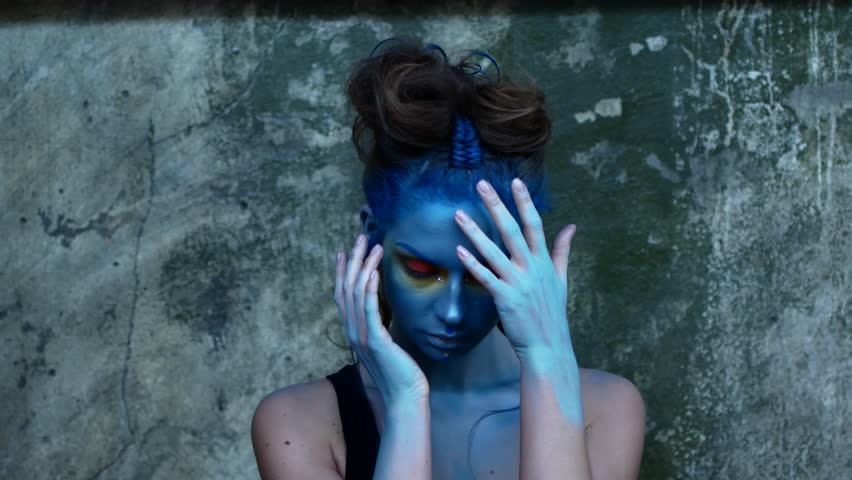 Creative make-up of blue color. Model body painting