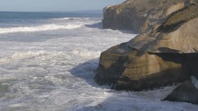 New Zealand Otago Peninsula Tunnel Beach wave crashing the cliffs slow motion