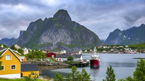 4k timelaspe Moving clouds over traditional Norwegian fisherman's cabins, rorbuer, on the island of Hamnoy, Reine, Lofoten islands, Summer of Norway.