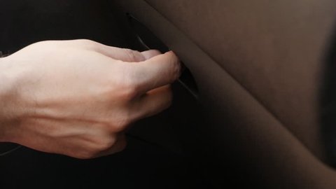 Hand opens car glove box slow motion video