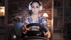 Woman playing a videogame at home using a racing steering wheel controller, she has lost the car race and feels disappointed