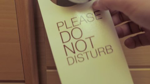 hanging card, do not disturb information on door handle in hotel room