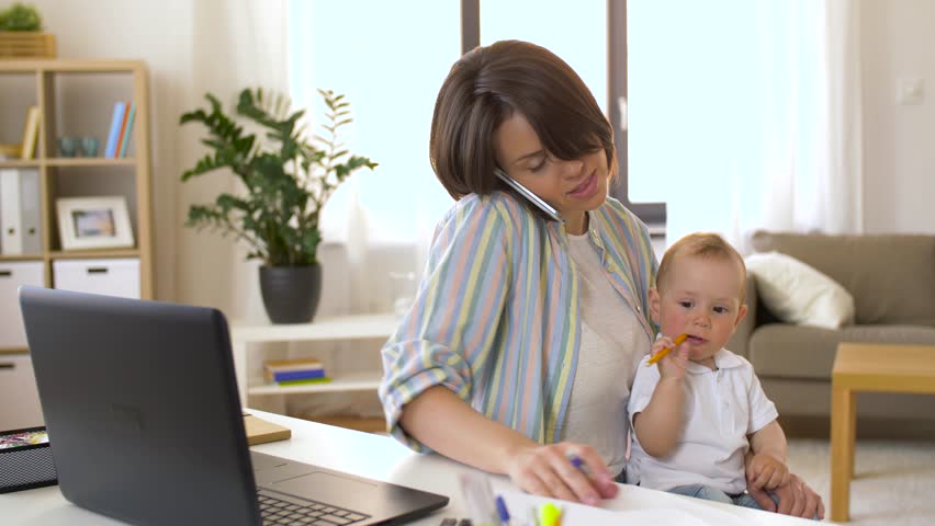 multi-tasking, freelance and motherhood concept - working mother with baby boy at home office calling on smartphone Royalty-Free Stock Footage #1011463196