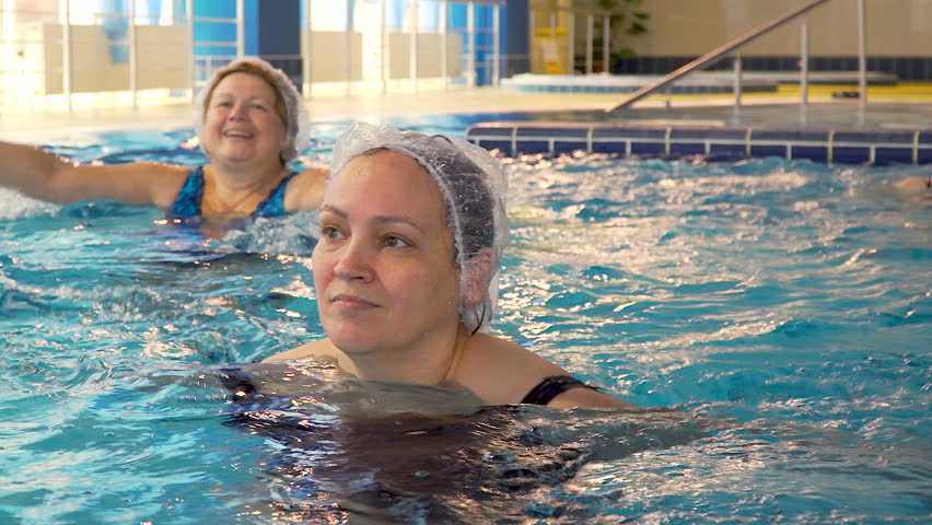 Group of senior women doing aqua aerobics exercises in the swimming pool | Shutterstock HD Video #1011467585