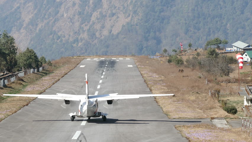 Takeoff plane in the mountains. Lukla airport, Himalayas. Extreme long shot. Royalty-Free Stock Footage #1011469958