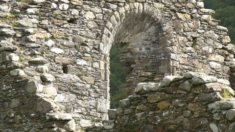 Glendalough , Ireland - May, 2016: Zoom in view of arched window of stone Cathedral in Glendalough