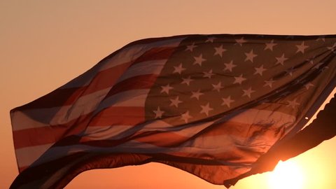 American Patriot with USA Flag During Scenic Sunset