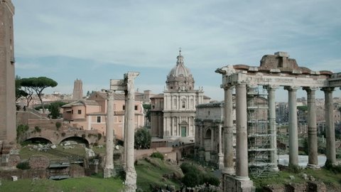 Tilt up panning right view of ancient Roman Forum or Foro Romano ruins seen from Capitoline Hill viewpoint in Rome, Italy. 4K UHD at 29.97fps