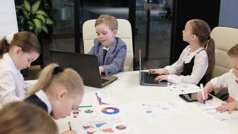 Group Of Children Work In A Modern Office