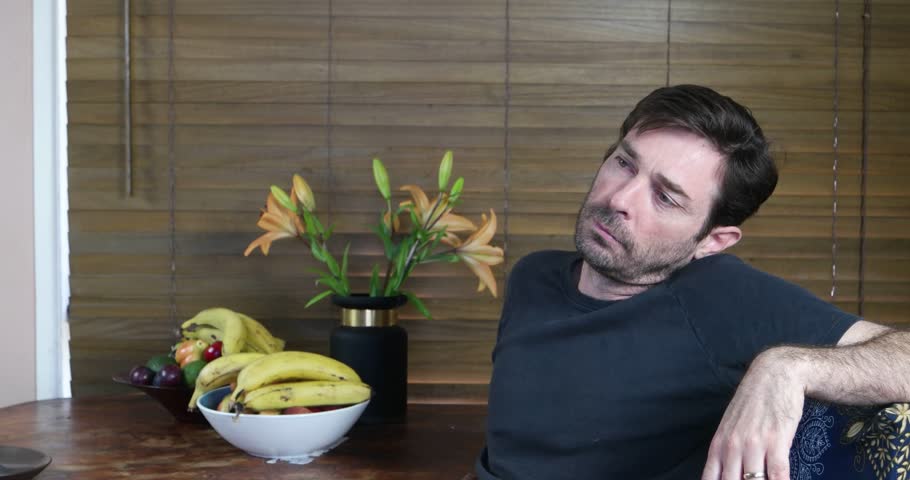 contemplative guy at table